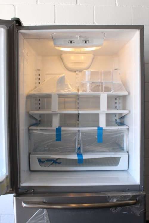 A quality Whirlpool stainless steel bottom freezer 620 litre fridge-freezer combo; never used