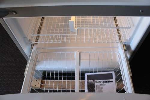 A quality Whirlpool stainless steel bottom freezer 620 litre fridge-freezer combo; never used