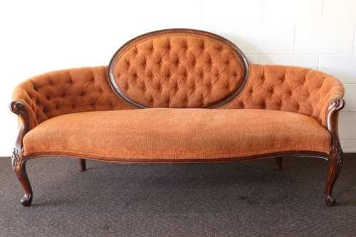 A beautiful antique Victorian Walnut deep-button camel-back sofa with stunning hand-carved detailing