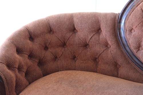 A beautiful antique Victorian Walnut deep-button camel-back sofa with stunning hand-carved detailing