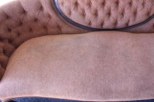 A beautiful antique Victorian Walnut deep-button camel-back sofa with stunning hand-carved detailing