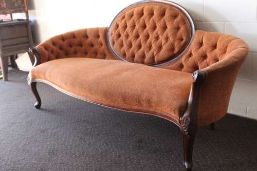 A beautiful antique Victorian Walnut deep-button camel-back sofa with stunning hand-carved detailing