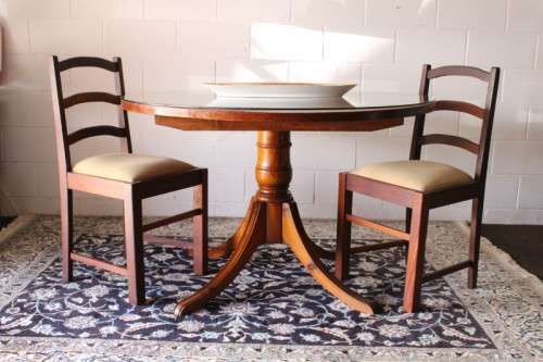 **RS17** A well made round glass-top hall/ foyer table w/ solid turned pedestal leg & broad fascia
