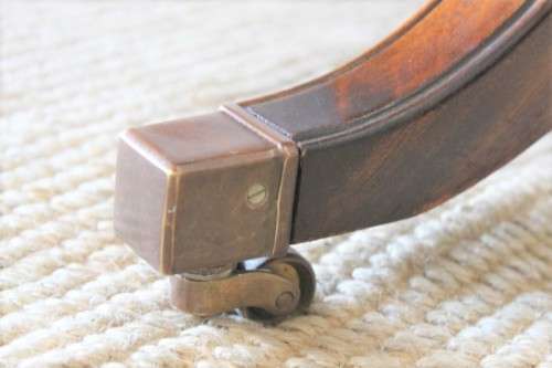 A beautiful vintage Regency styled ladies embossed leather-top 3-drawer writing desk on castors