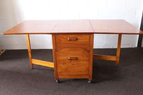 A stunning & unusual vintage oak drop-leaf dining table with a cupboard and three storage drawers