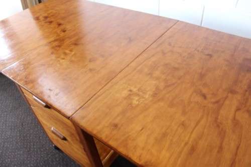 A stunning & unusual vintage oak drop-leaf dining table with a cupboard and three storage drawers