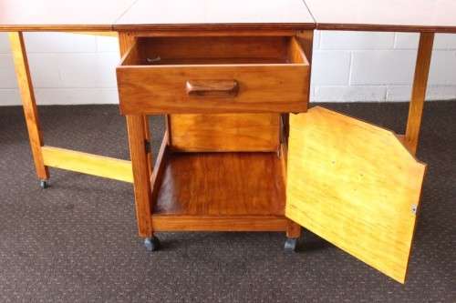 A stunning & unusual vintage oak drop-leaf dining table with a cupboard and three storage drawers