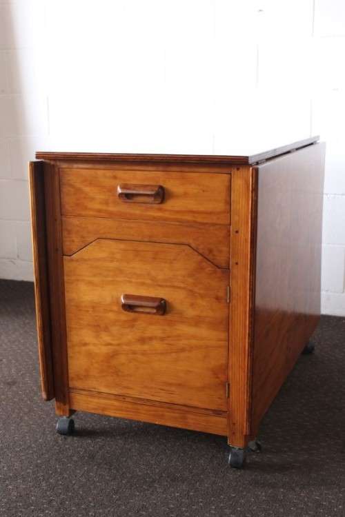 A stunning & unusual vintage oak drop-leaf dining table with a cupboard and three storage drawers