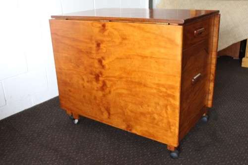 A stunning & unusual vintage oak drop-leaf dining table with a cupboard and three storage drawers