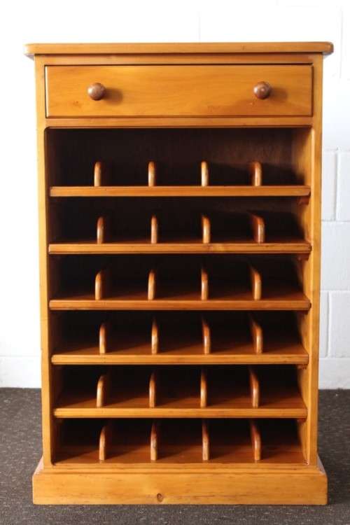 An incredible and beautifully made solid oregon wood 30-bottle wine rack with a smalls drawer
