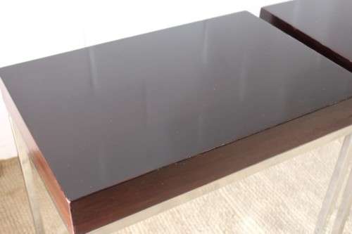 A fabulous pair of modern styled chromed-framed coffee tables with a broad wood profiles