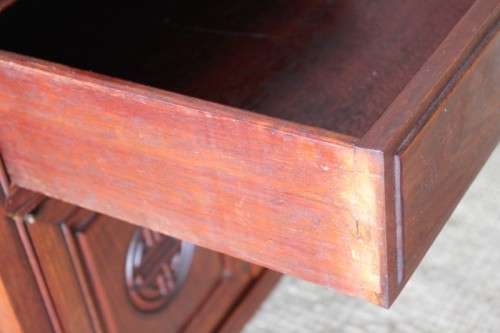 A beautifully carved oriental Elm wood "end" cupboard with brass symbol handles and a drawer