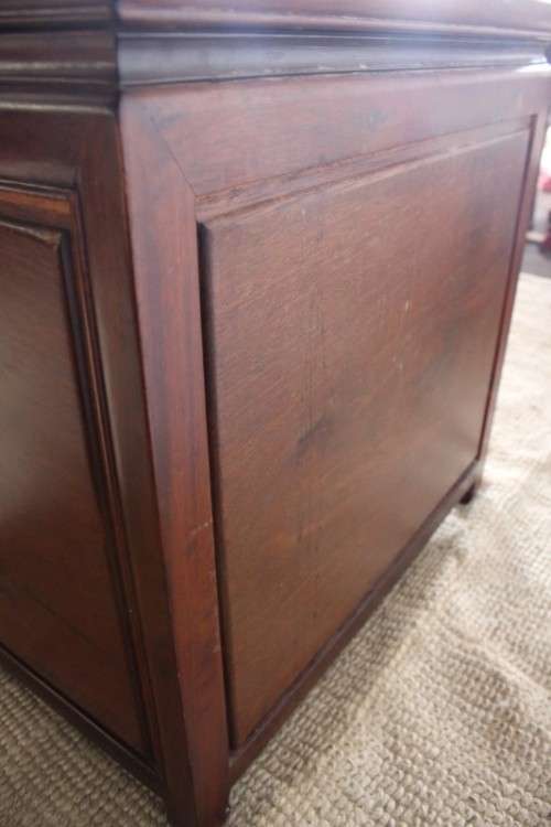 A beautifully carved oriental Elm wood "end" cupboard with brass symbol handles and a drawer