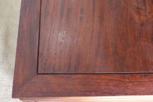 A beautifully carved oriental Elm wood "end" cupboard with brass symbol handles and a drawer