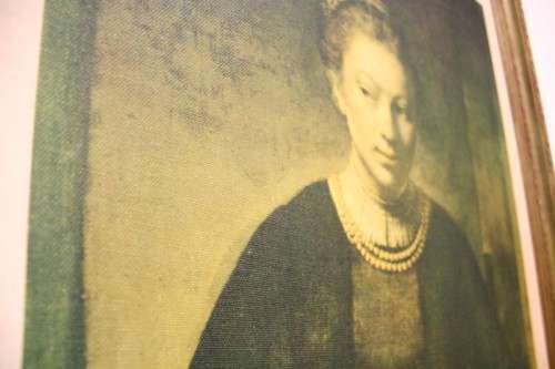 A lovely framed silk screen of the famous Rembrandt "Young Girl at an Open Half Door"