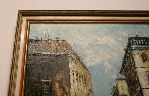 A beautiful framed original signed oil painting of a town scene.