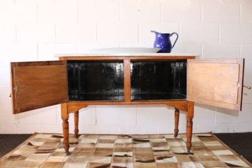 A wonderful vintage solid Oak double door wash stand with a white marble top on castors - stunning!