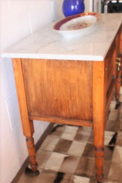 A wonderful vintage solid Oak double door wash stand with a white marble top on castors - stunning!