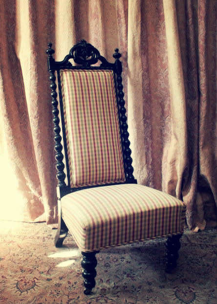 **RS17** A gorgeous Victorian "parlour chair" w/ carved detailing & chequered upholstery on castors.