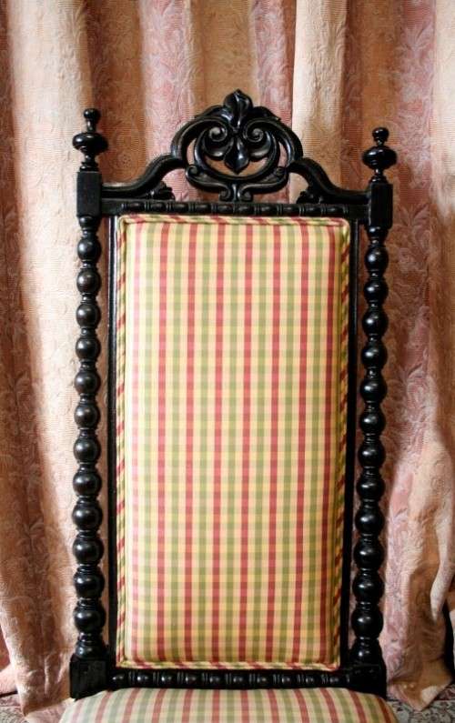 **RS17** A gorgeous Victorian "parlour chair" w/ carved detailing & chequered upholstery on castors.