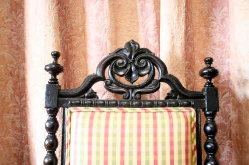 **RS17** A gorgeous Victorian "parlour chair" w/ carved detailing & chequered upholstery on castors.