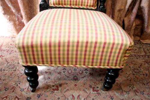 **RS17** A gorgeous Victorian "parlour chair" w/ carved detailing & chequered upholstery on castors.