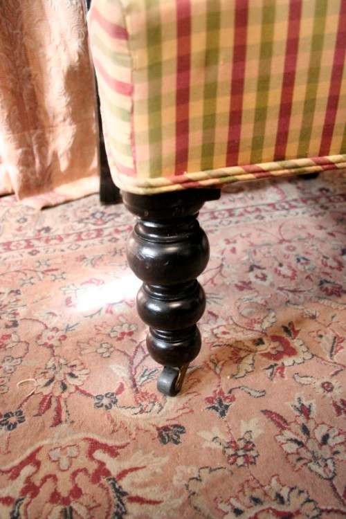 **RS17** A gorgeous Victorian "parlour chair" w/ carved detailing & chequered upholstery on castors.