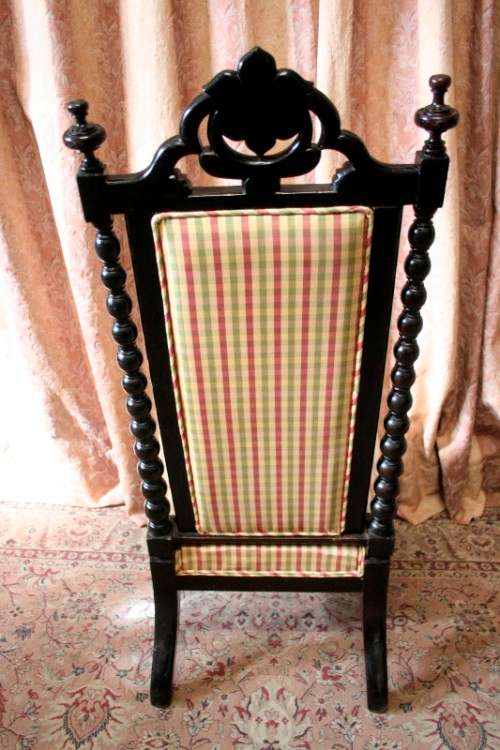 **RS17** A gorgeous Victorian "parlour chair" w/ carved detailing & chequered upholstery on castors.