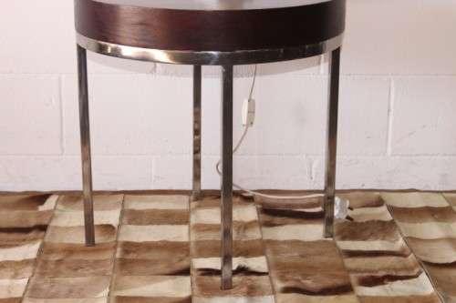 A wonderful modern styled round steel frame coffee/ side table with a broad wood profile