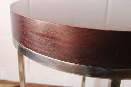 A wonderful modern styled round steel frame coffee/ side table with a broad wood profile
