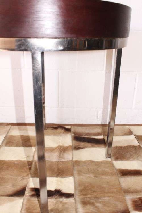A wonderful modern styled round steel frame coffee/ side table with a broad wood profile
