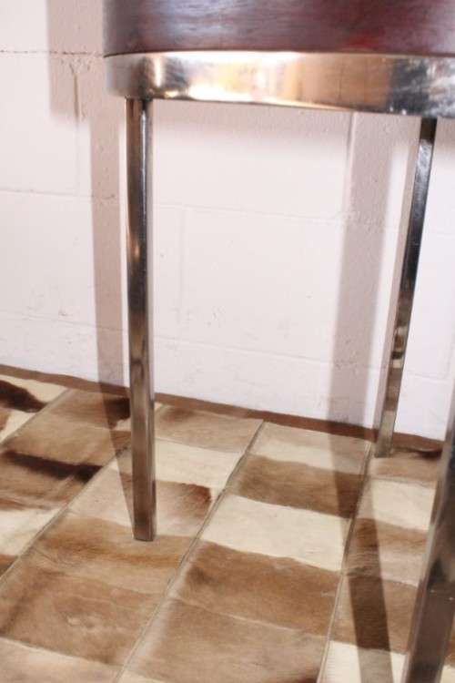 A wonderful modern styled round steel frame coffee/ side table with a broad wood profile