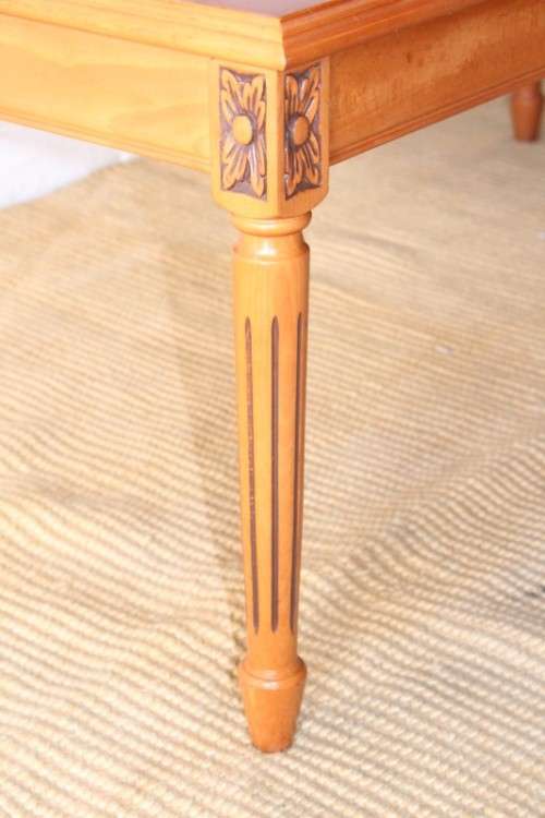 A stunning and stylish Yew wood centre coffee table with carved detailing on tapered legs