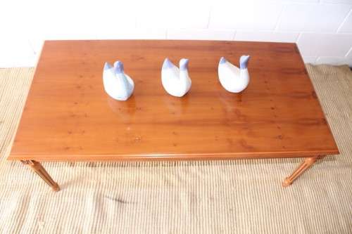 A stunning and stylish Yew wood centre coffee table with carved detailing on tapered legs