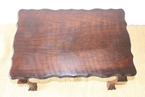 A great size vintage scalloped edge solid African Stink wood ball and claw coffee/ side table