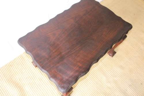 A great size vintage scalloped edge solid African Stink wood ball and claw coffee/ side table
