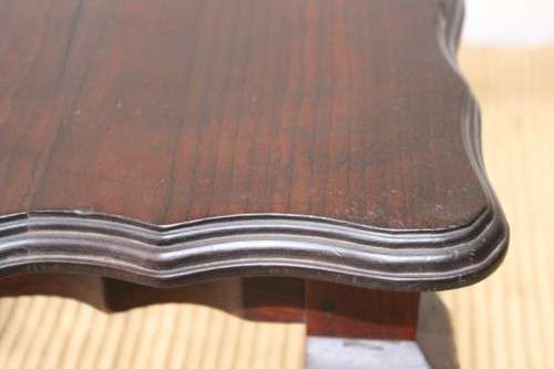 A great size vintage scalloped edge solid African Stink wood ball and claw coffee/ side table