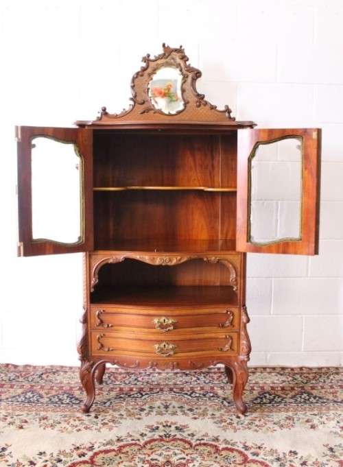 A beautiful antique French Mahogany cabinet with curved glass doors and a bevelled glass mirror