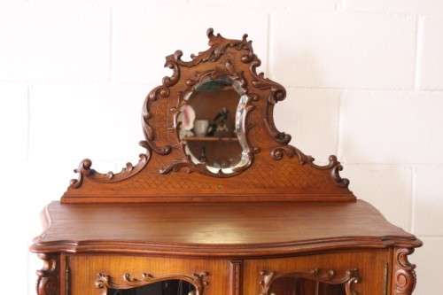 A beautiful antique French Mahogany cabinet with curved glass doors and a bevelled glass mirror