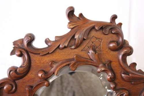 A beautiful antique French Mahogany cabinet with curved glass doors and a bevelled glass mirror