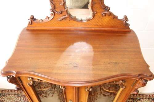 A beautiful antique French Mahogany cabinet with curved glass doors and a bevelled glass mirror