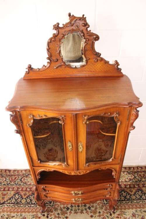 A beautiful antique French Mahogany cabinet with curved glass doors and a bevelled glass mirror
