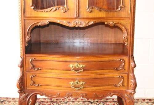 A beautiful antique French Mahogany cabinet with curved glass doors and a bevelled glass mirror
