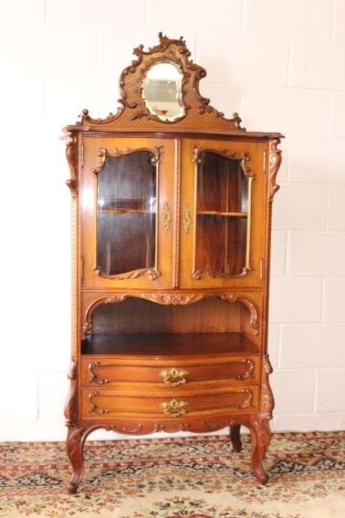 A beautiful antique French Mahogany cabinet with curved glass doors and a bevelled glass mirror