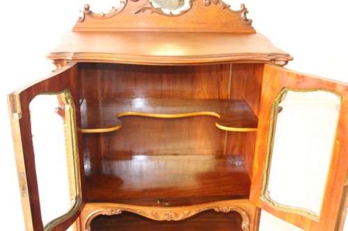A beautiful antique French Mahogany cabinet with curved glass doors and a bevelled glass mirror