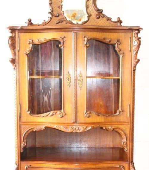 A beautiful antique French Mahogany cabinet with curved glass doors and a bevelled glass mirror