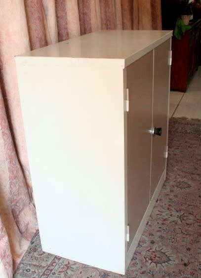 A sturdy metal multi purpose cabinet with a large cupboard, needs some tlc, perfect to paint!