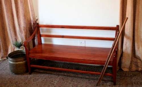 A wonderful well-made, sturdy vintage three seater  wood bench - perfect  in a lapa/ patio!