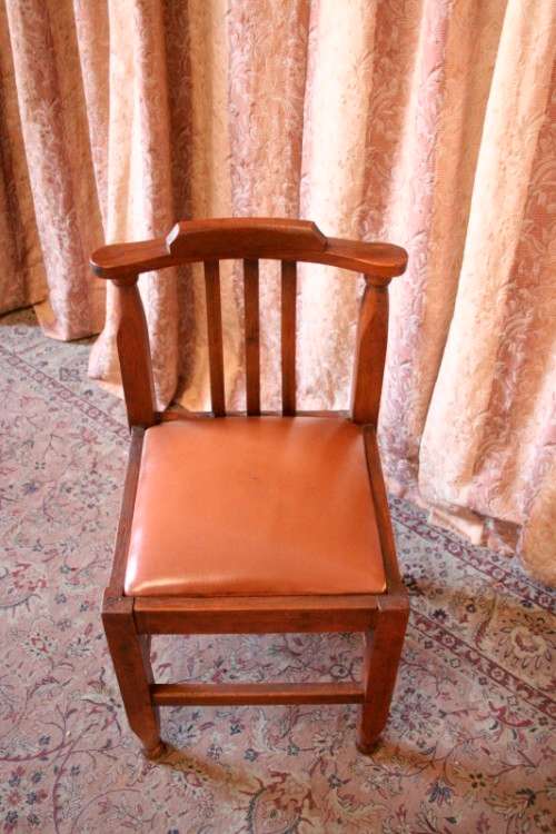 **RS17** A lovely and very well made antique oak chair with a brown PU leather upholstered seat