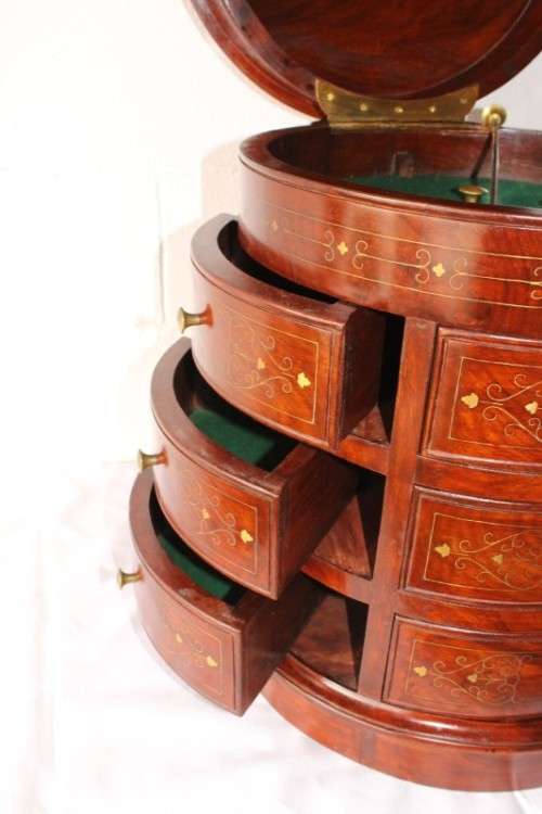 A spectacular and beautifully made solid rosewood round 12-drawer jewellery chest with brass inlay